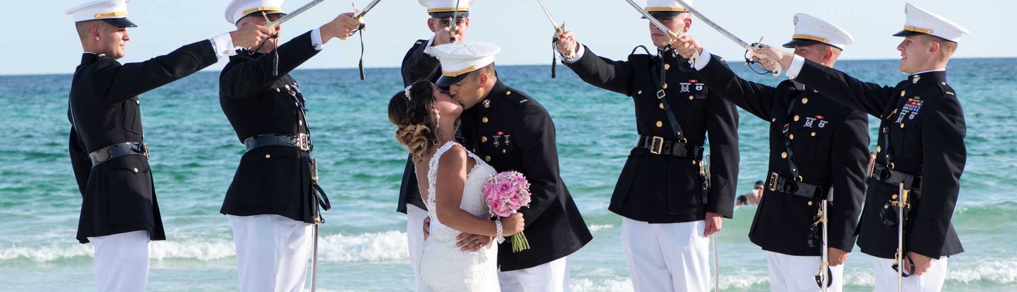 Marines holding swords over married couple during Destin Beach Wedding