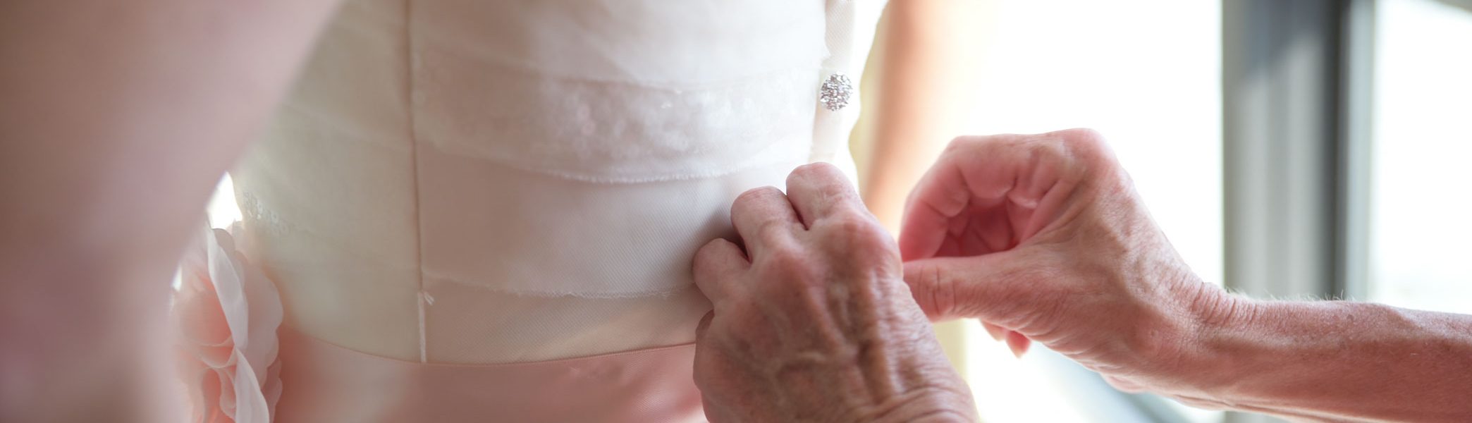 Elder Woman's hands helping Bride before Island Sands Beach Wedding