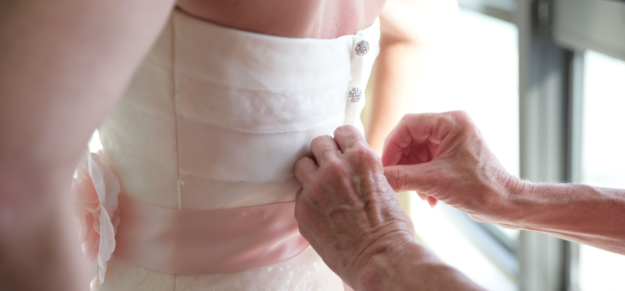 Elder Woman's hands helping Bride before Island Sands Beach Wedding